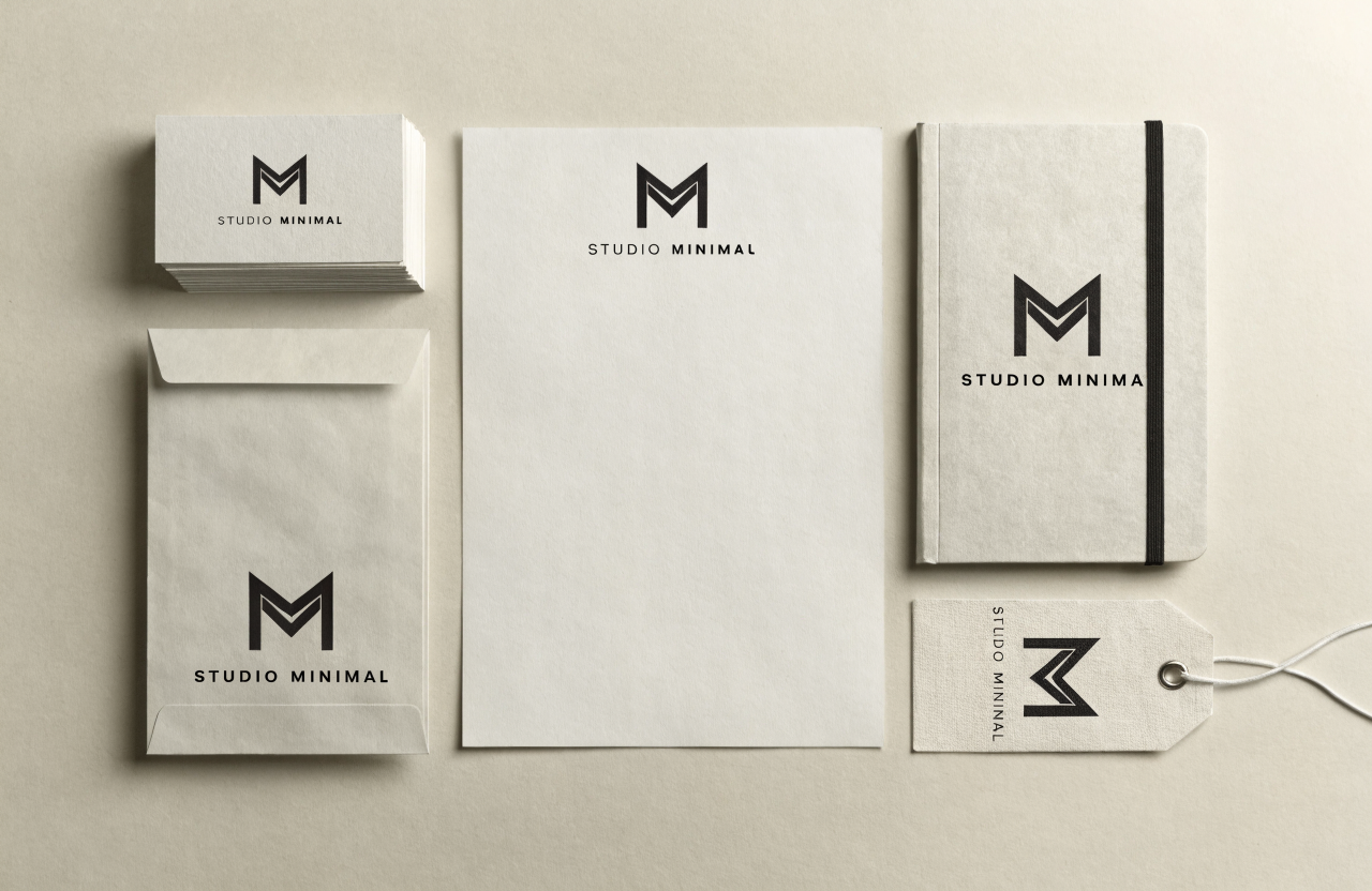 Full brand stationery suite mockup with a minimalist monogram
